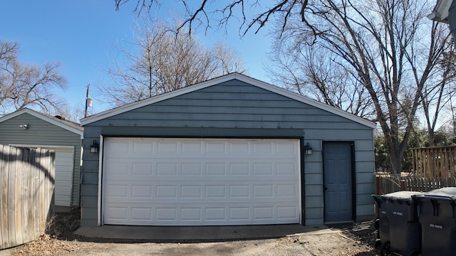 detached garage featuring fence