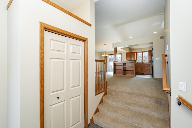 424 11th St NW, Byron, MN 55920 - stairway featuring recessed lighting, an inviting chandelier, and carpet floors