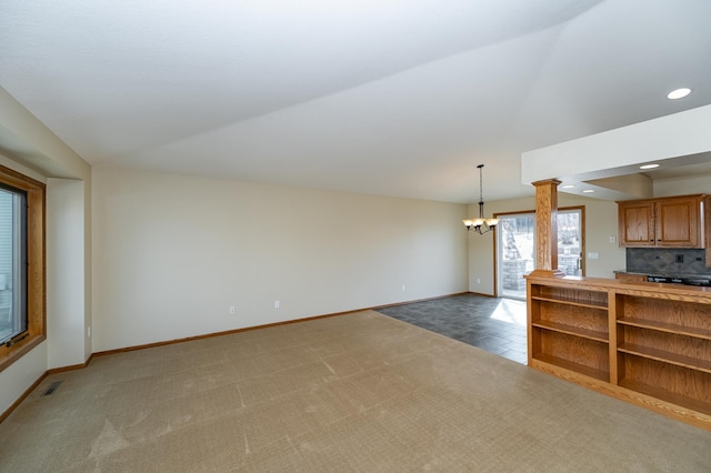 424 11th St NW, Byron, MN 55920 - unfurnished living room featuring baseboards, a notable chandelier, visible vents, and light colored carpet