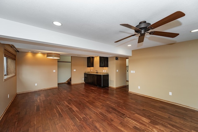 424 11th St NW, Byron, MN 55920 - unfurnished living room with wet bar, dark wood-style flooring, ceiling fan, and recessed lighting