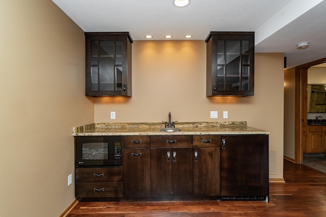 424 11th St NW, Byron, MN 55920 - bar featuring baseboards, dark wood-style floors, and black microwave