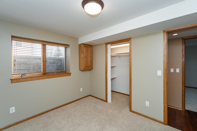 424 11th St NW, Byron, MN 55920 - unfurnished bedroom with baseboards, a spacious closet, a closet, and carpet
