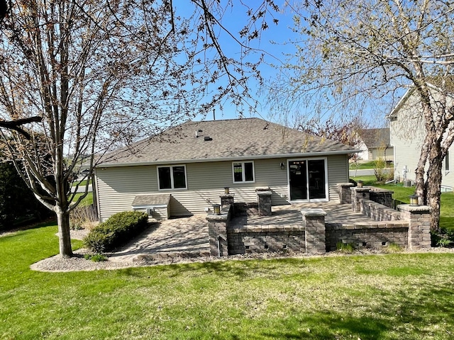 424 11th St NW, Byron, MN 55920 - rear view of house with a lawn, a patio, and a shingled roof