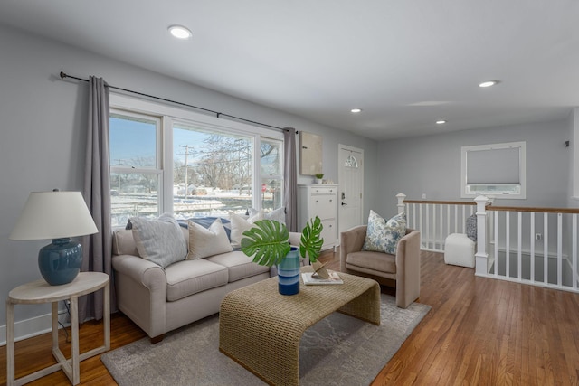 living room featuring recessed lighting, baseboards, and wood finished floors