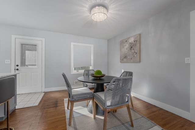 dining room featuring baseboards and wood finished floors