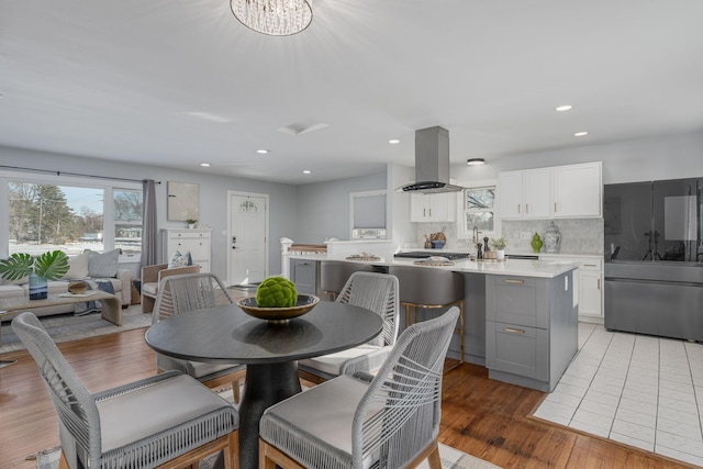 dining area with recessed lighting, a healthy amount of sunlight, and light wood finished floors