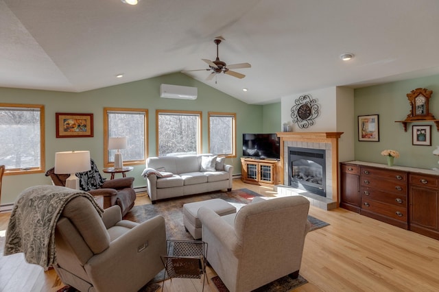 living room featuring light wood-type flooring, plenty of natural light, vaulted ceiling, and a wall mounted AC