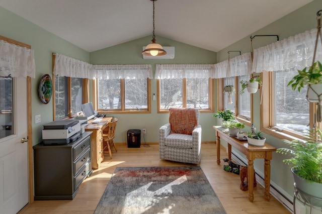 sitting room with vaulted ceiling, light wood-style floors, and a baseboard radiator