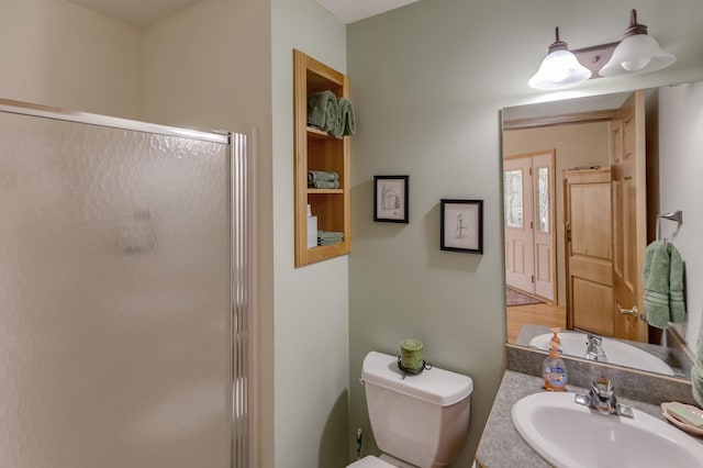 full bath featuring a shower stall, toilet, and a sink