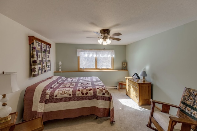 bedroom with a ceiling fan, a textured ceiling, carpet floors, baseboards, and baseboard heating