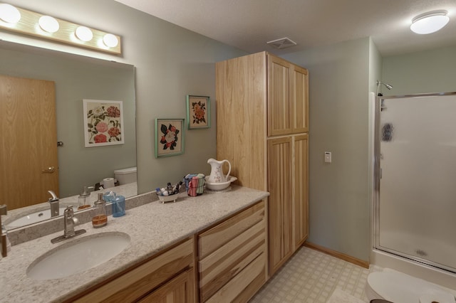 bathroom with tile patterned floors, visible vents, a stall shower, and toilet