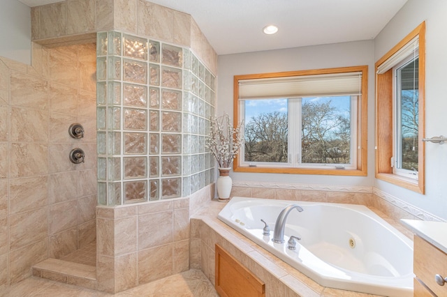 bathroom featuring a jetted tub and walk in shower