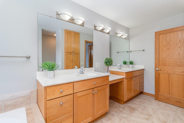 full bath featuring two vanities and a sink