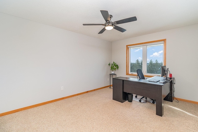 office area with baseboards, light colored carpet, and ceiling fan