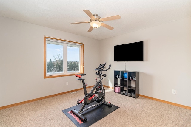 workout area with baseboards, carpet floors, and ceiling fan