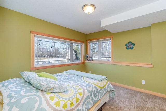 bedroom with baseboards and carpet flooring