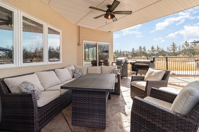 view of patio / terrace with an outdoor living space, area for grilling, fence, and ceiling fan