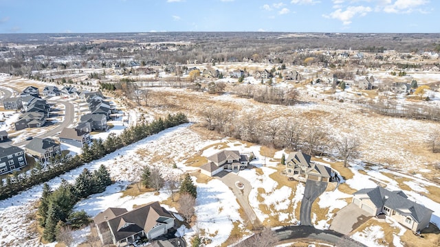 snowy aerial view featuring a residential view