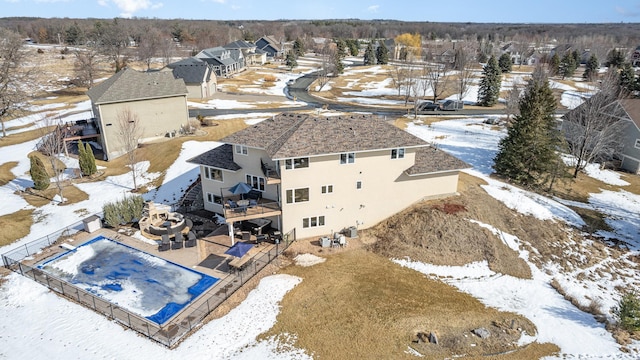 snowy aerial view featuring a residential view