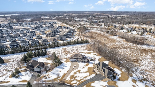 snowy aerial view with a residential view