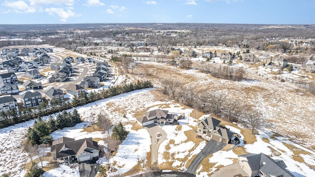 snowy aerial view featuring a residential view