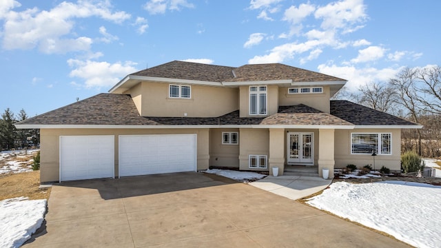 view of front of house featuring stucco siding, driveway, french doors, a shingled roof, and a garage