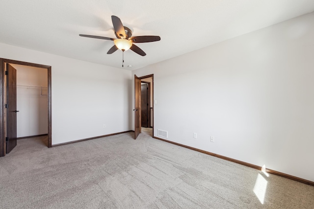 unfurnished bedroom featuring visible vents, ceiling fan, baseboards, light carpet, and a closet