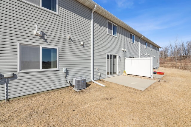 rear view of property with central AC