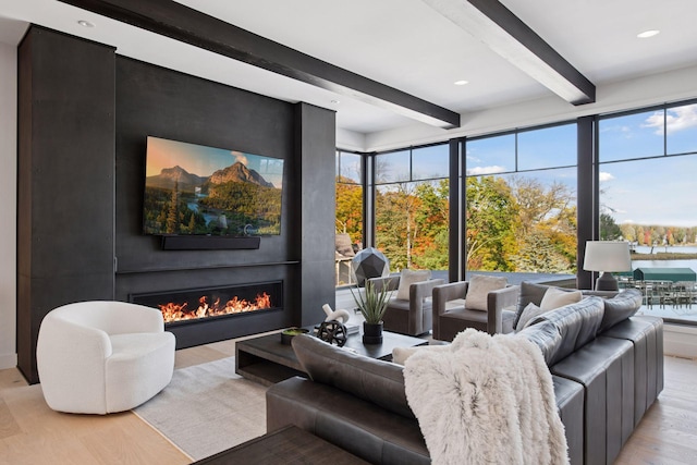 living room with beam ceiling, light wood-style flooring, recessed lighting, and a large fireplace