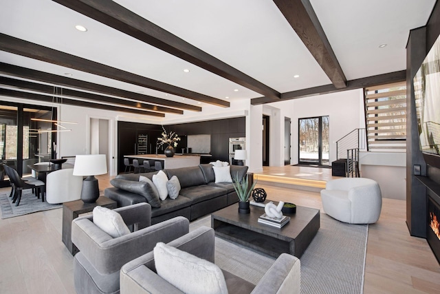 living area with beamed ceiling, recessed lighting, and wood finished floors