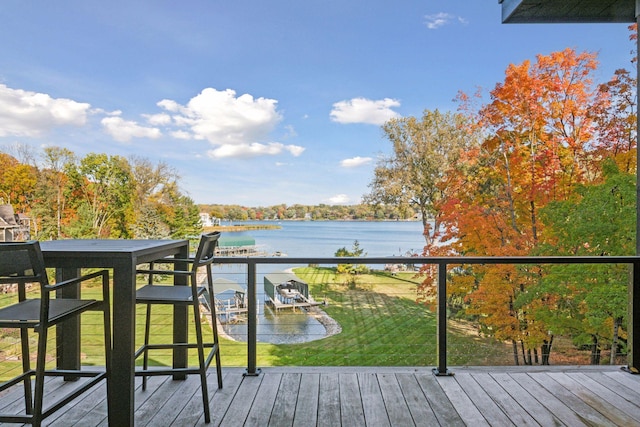 wooden deck featuring a yard and a water view