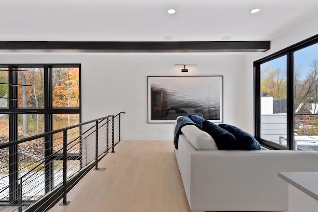 living room with recessed lighting, beamed ceiling, and light wood-style floors