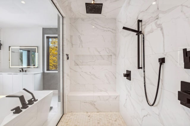 bathroom with a marble finish shower, a tub to relax in, and a sink