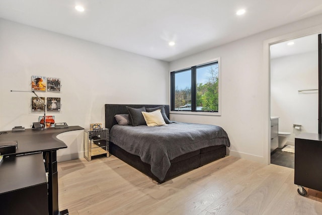 bedroom featuring recessed lighting, baseboards, ensuite bath, and light wood-style flooring