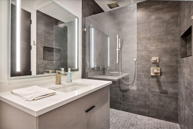 bathroom featuring vanity, a walk in shower, and visible vents