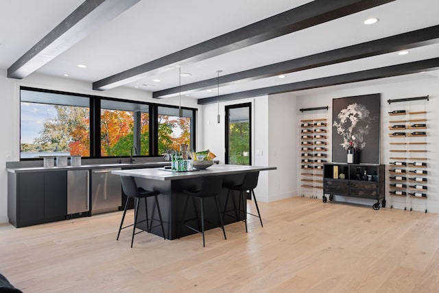 dining space with recessed lighting, light wood-type flooring, beam ceiling, and baseboards