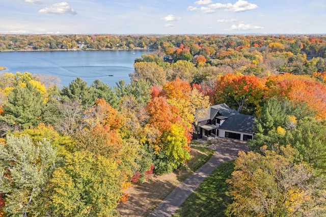 birds eye view of property with a water view and a wooded view