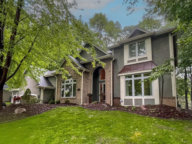 6331 Summit Cir, Chanhassen, MN 55317 - view of front of house with brick siding, a front yard, and a standing seam roof