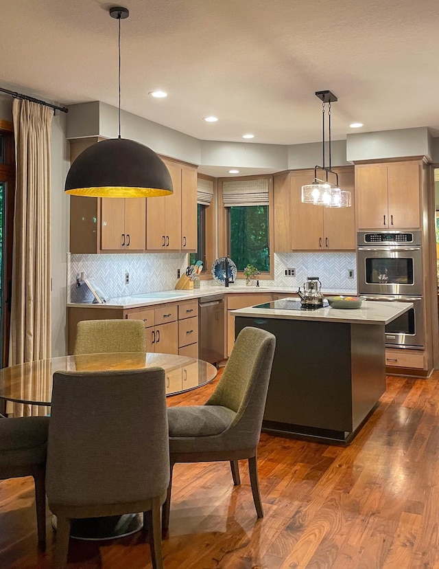 6331 Summit Cir, Chanhassen, MN 55317 - kitchen featuring light brown cabinets, appliances with stainless steel finishes, light countertops, decorative backsplash, and recessed lighting