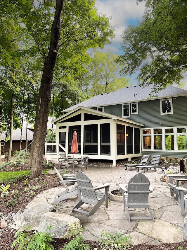 6331 Summit Cir, Chanhassen, MN 55317 - rear view of property featuring a fire pit, a sunroom, and a patio