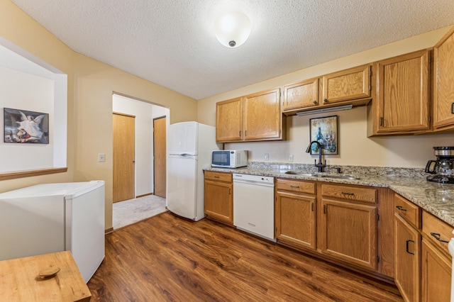 8031 Xerxes Ave S Unit 225, Bloomington, MN 55431 - kitchen featuring white appliances, light stone countertops, dark wood-style floors, a textured ceiling, and a sink