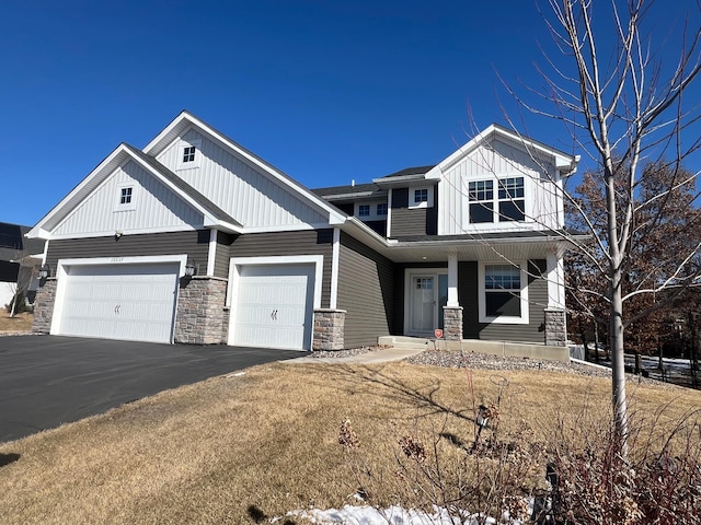 view of front of home with aphalt driveway, a garage, board and batten siding, and a porch