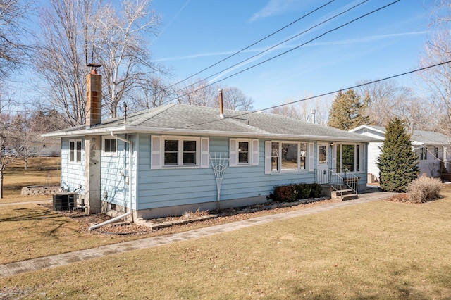 single story home with a chimney, central AC, a front lawn, and a shingled roof