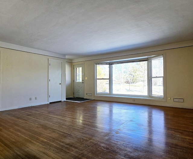 unfurnished living room featuring wood finished floors