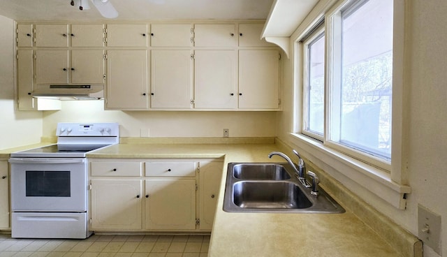 kitchen with ceiling fan, a sink, light countertops, electric stove, and under cabinet range hood