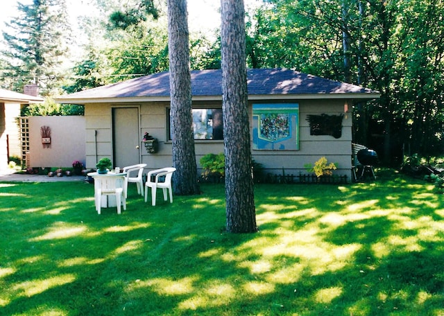 back of house with a lawn