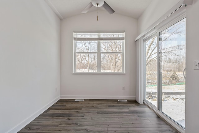 unfurnished room with baseboards, a ceiling fan, lofted ceiling, and dark wood-style flooring