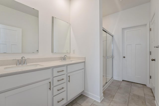 bathroom featuring a sink, a stall shower, and tile patterned floors