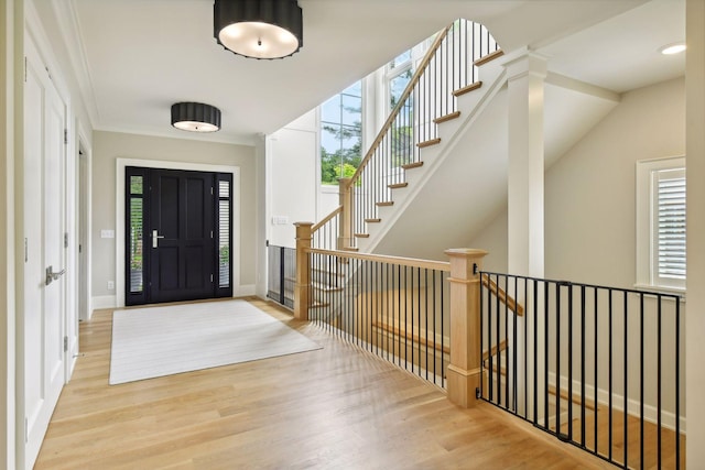 entryway featuring a wealth of natural light, baseboards, and wood finished floors