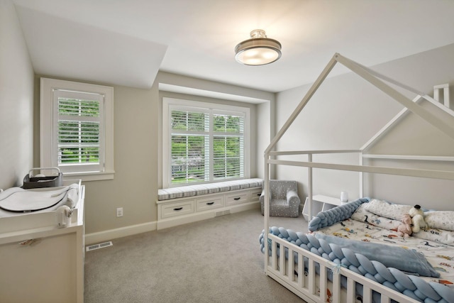 bedroom with visible vents, light carpet, and baseboards